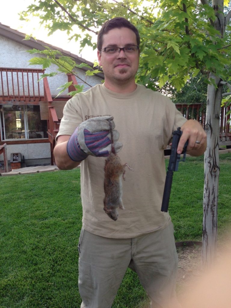 Jonathon Shults fending off a large rat at his home in UT