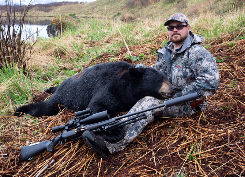 Jonathon Shults in Alaska with a black bear he hunted using the SilencerCo Harvester 300 and an early iteration of the SWR Radius