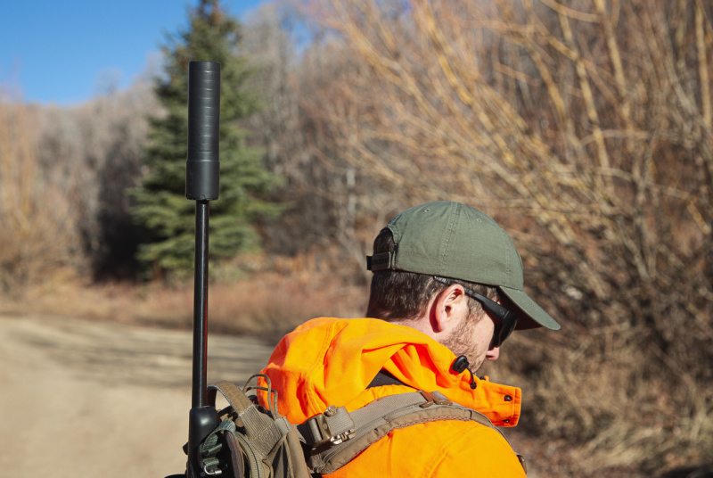 SilencerCo Harvester Evo suppressor on rifle in hunter's backpack
