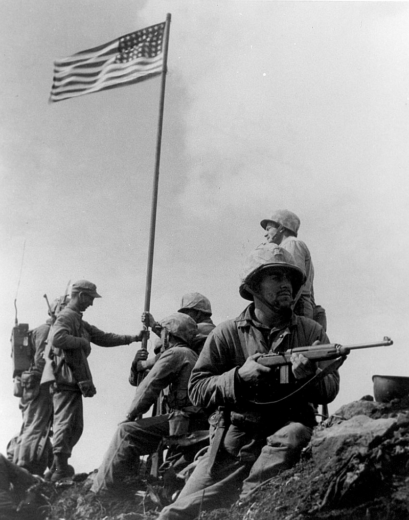 A US Marine stands guard at Iwo Jima with an M-1 Carbine