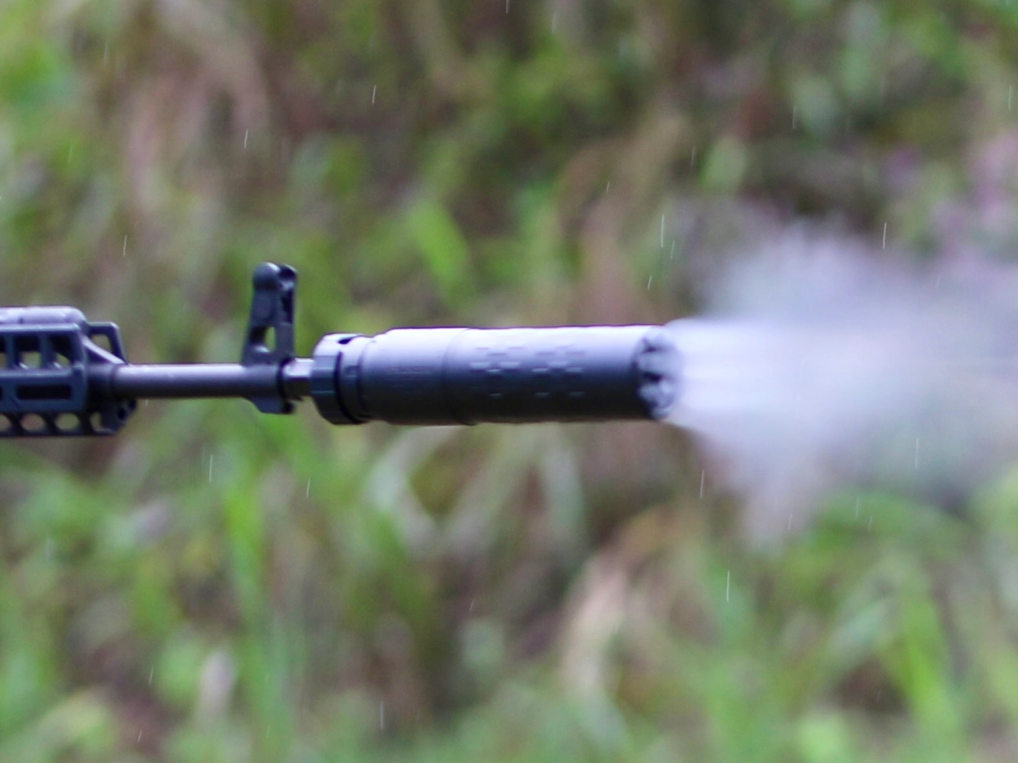 gas vening from front of suppressor on suppressed AK rifle