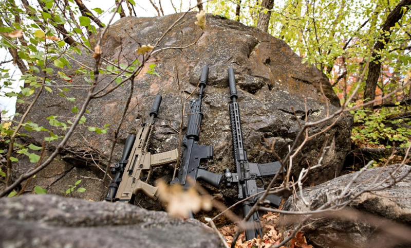 three rifles with SilencerCo suppressors