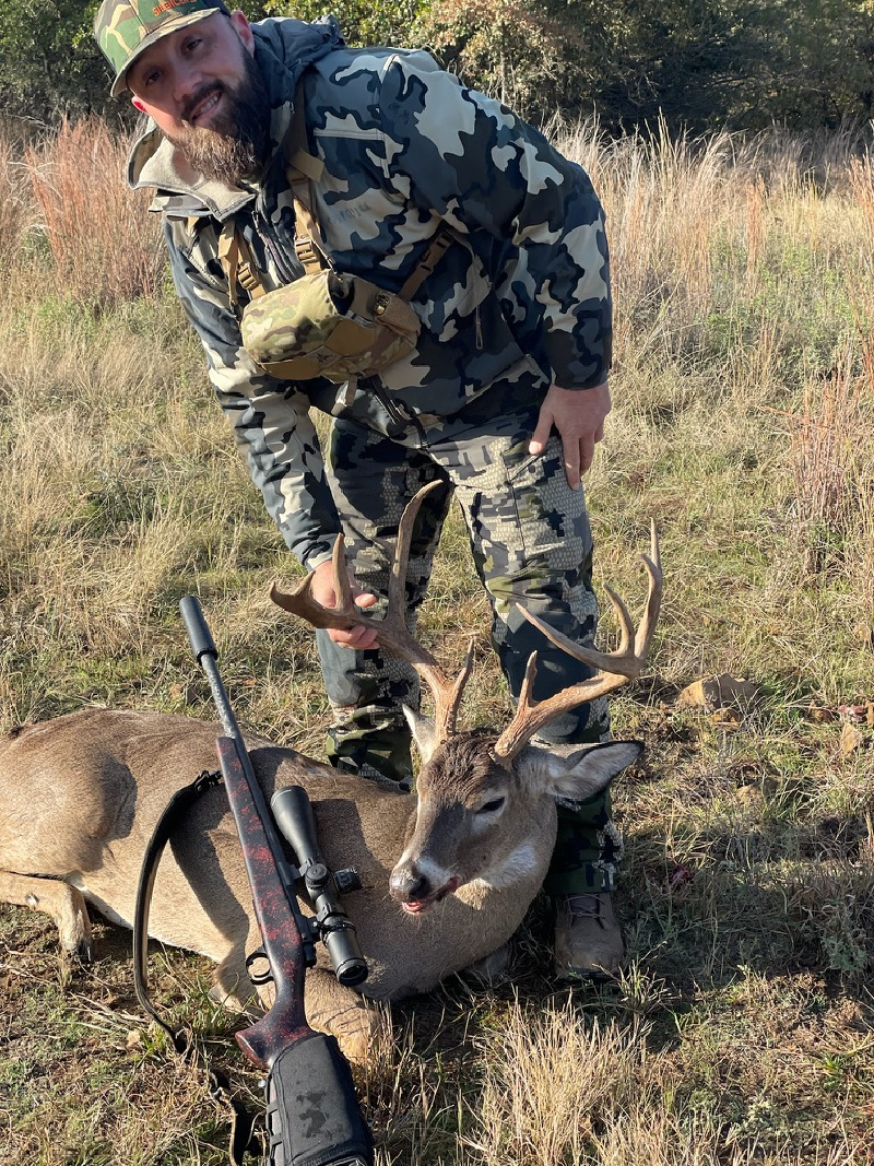 Chase Glenn with a buck he took down hunting suppressed.