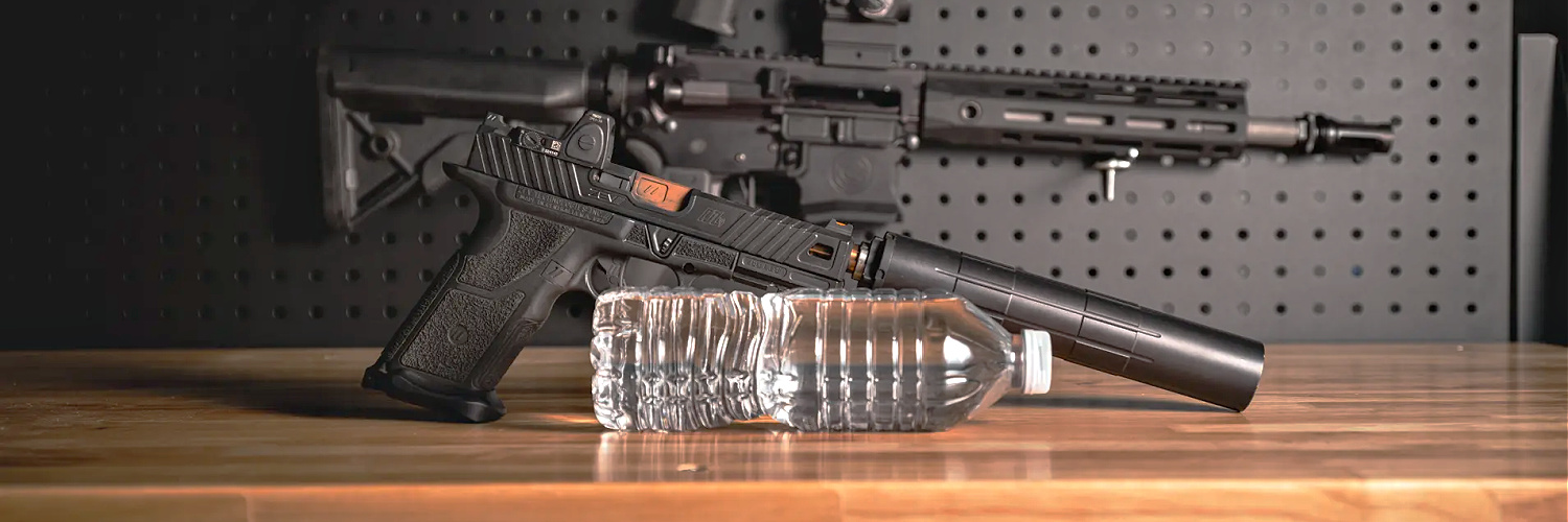 shooting suppressors wet feature image - suppressed handgun with bottle of water