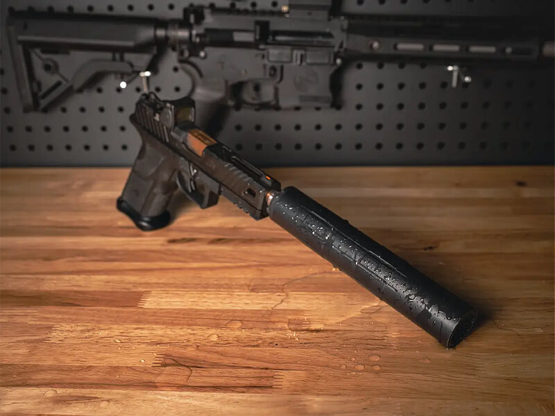 Wet suppressor mounted to a handgun