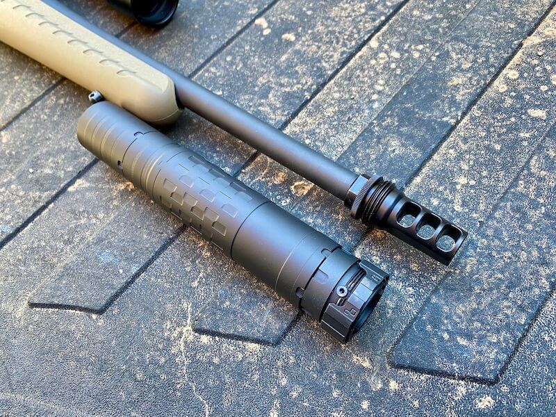 SilencerCo Hybrid 46M with ASR Mount, next to a Ruger American Rifle with a muzzle brake mounted to the barrel.
