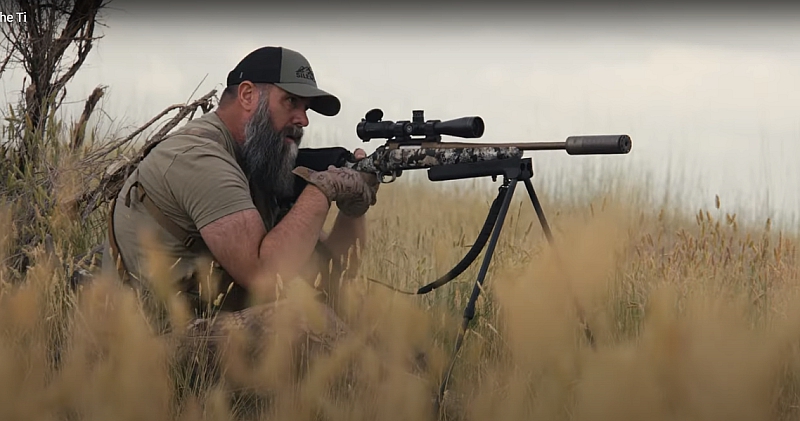man hunting with rifle suppressed with a SilencerCo Scythe-Ti suppressor.