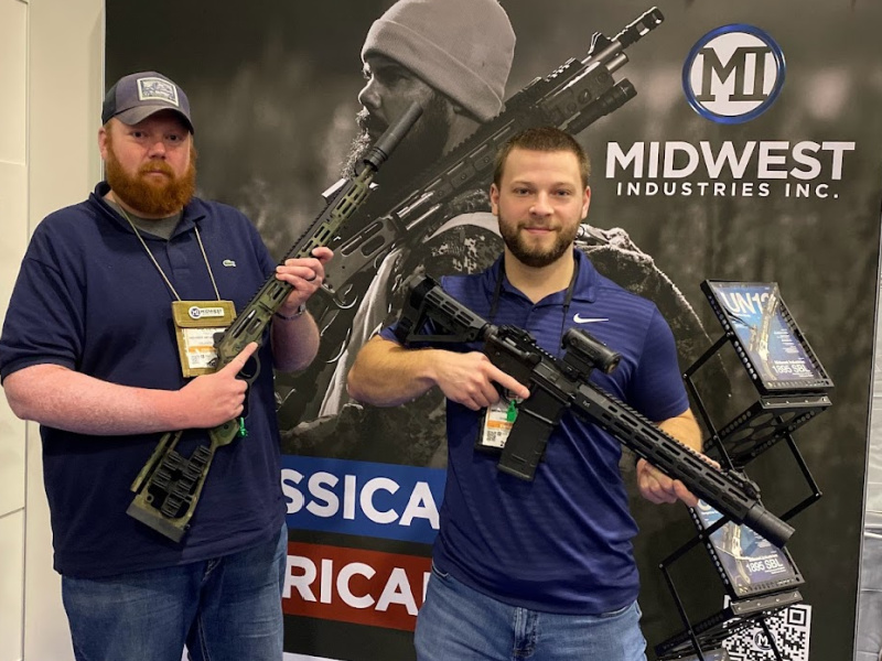 Midwest Industries at SHOT Show 2024 with suppressed rifles. Rossi lever action 45-70 rifle suppressed with Velos 7.62. 300 BLK AR pistol with a suppressor compatible handguard, suppressed with the SilencerCo 36M. Both with ASR mounts.