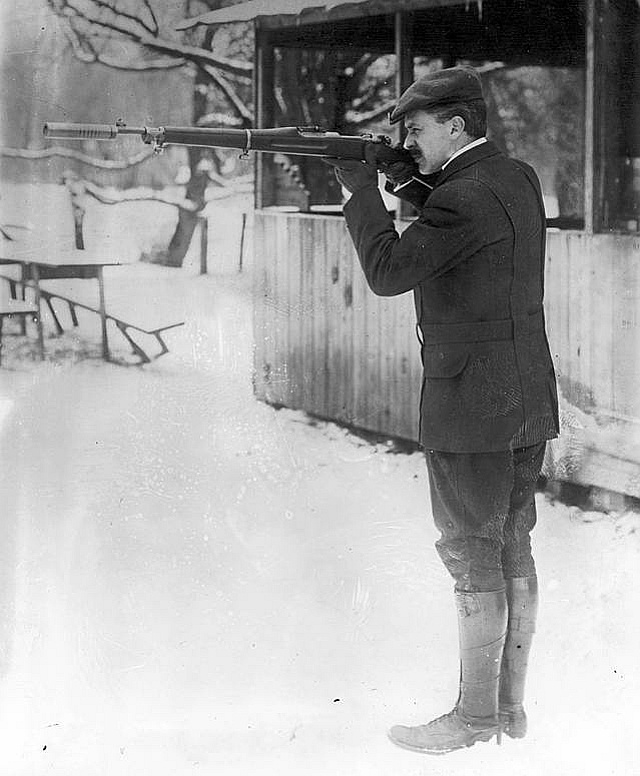 Hiram Percy Maxim demonstrates his Model 1910 Silencer on an M-1903 Springfield rifle. (Public Domain)