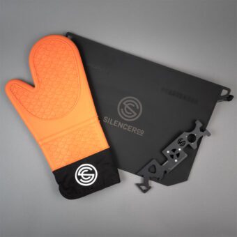 orange suppressor mit, omni tool, and a magpul sealable bag on a grey background