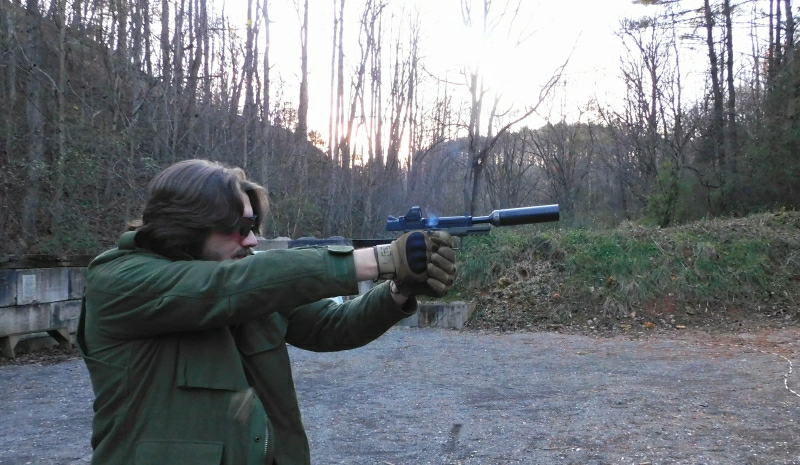 man shooting IWI Masada Tactical suppressed