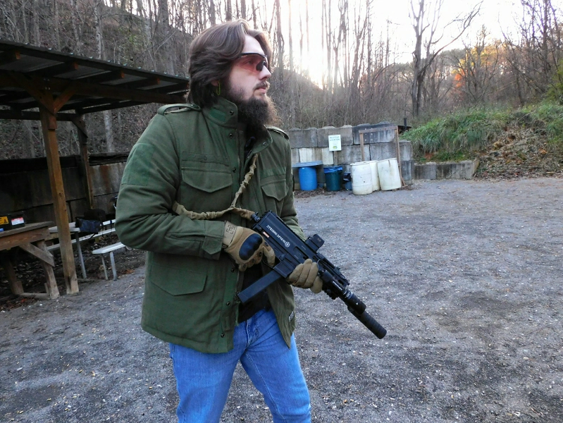 Man holding Stribog sp9a3 with Spectre 9 in low ready