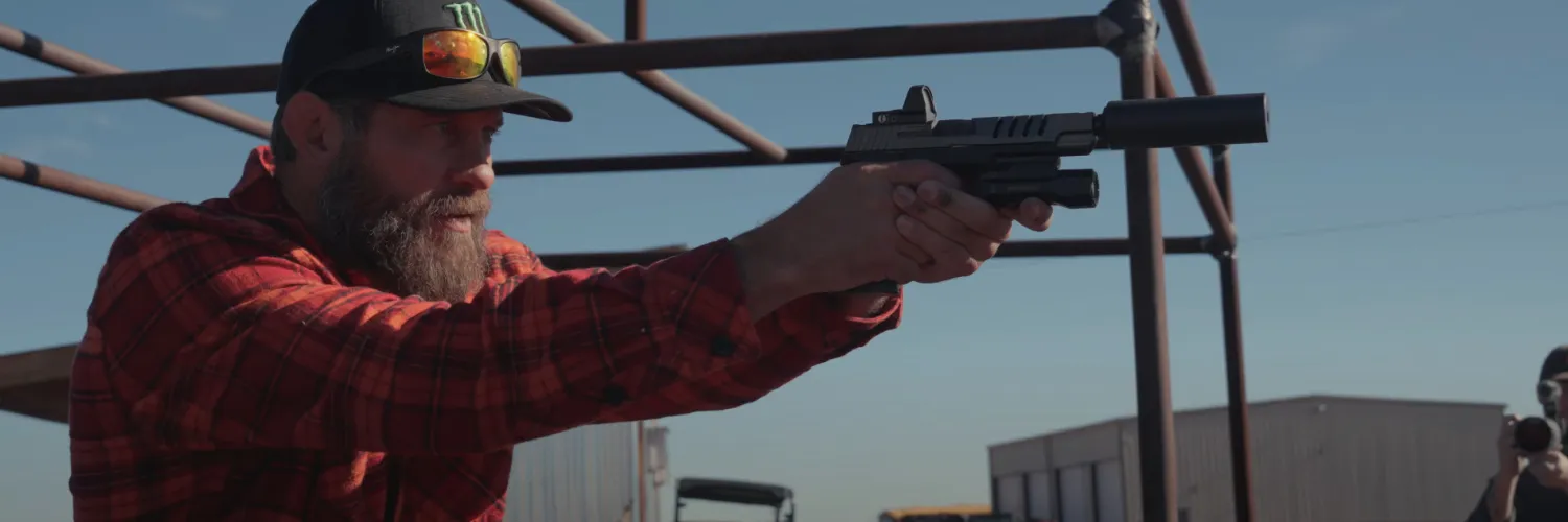 Cowboy Cerrone shooting a pistol with SilencerCo suppressor