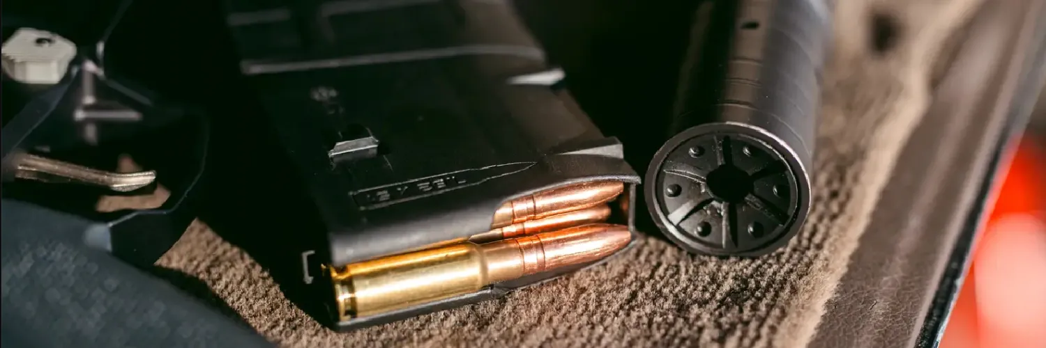 .338 ARC cartridges in a magazine, next to supppressor