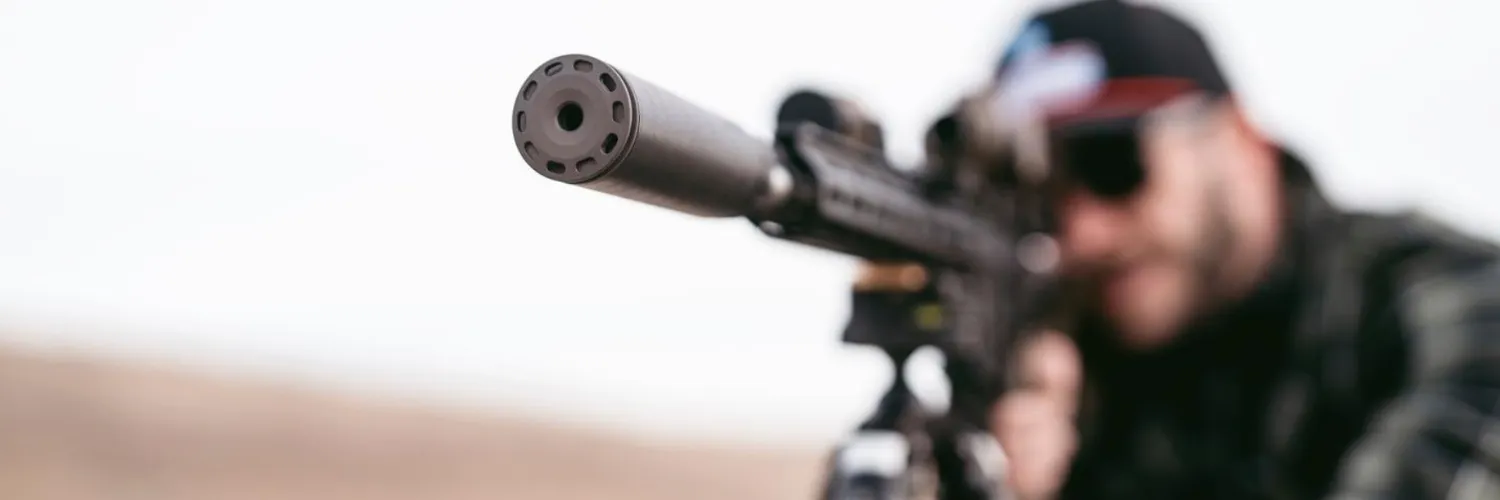 man shooting rifle with SilencerCo suppressor