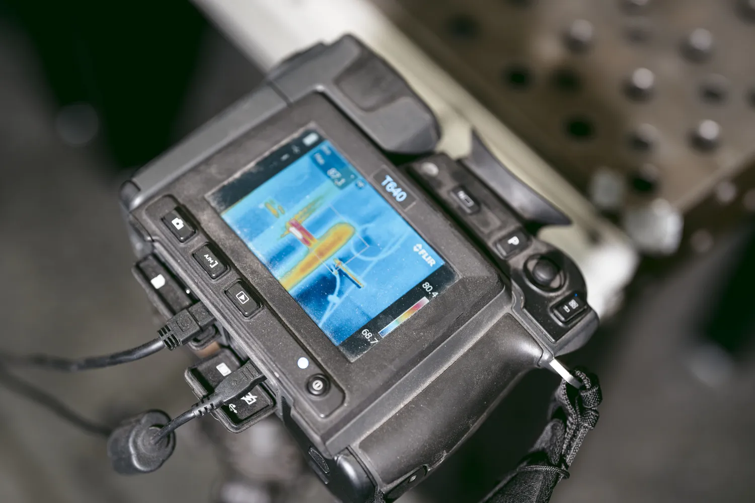 A Flir thermal camera gathers thermal data from a suppressor during testing.