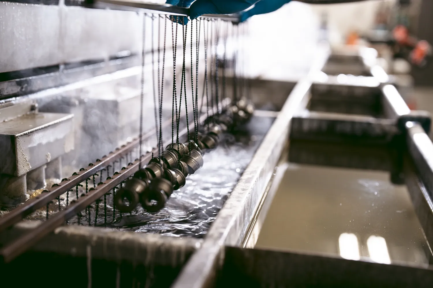 SilencerCo thread mounts being pulled from last bath in the Black Oxide tank.