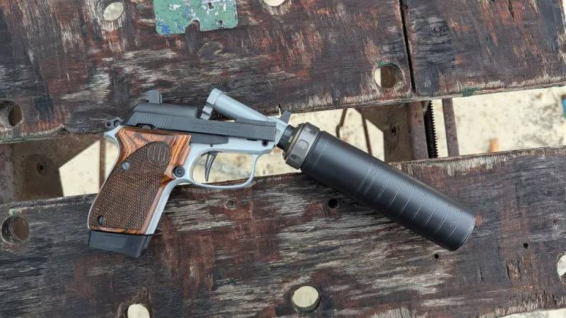 beretta 30x Tomcat with barrel tilted up and SilencerCo Spectre 9 suppressor attached