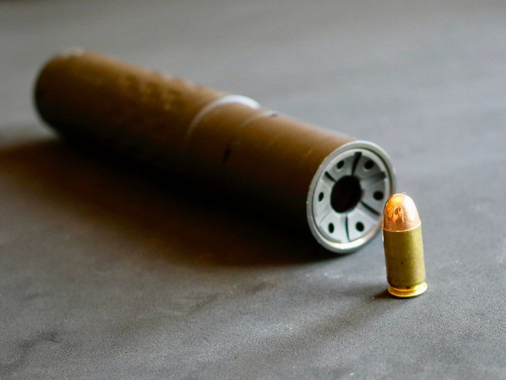 SilencerCo Hybrid 46M with a round of .45 caliber ammo