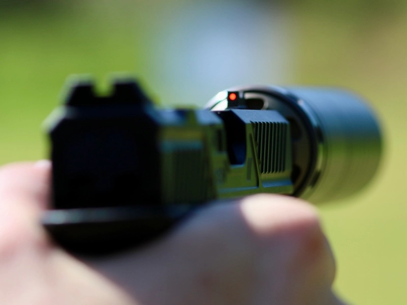 The factory sights on this Zev are not high. The red fiberoptic insert glows well enough that the sight can still be seen against the Spectre 9.