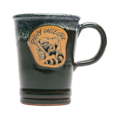 A Green SilencerCo Shiny Collector Deneen Pottery 16 Oz. Commuter Mug.