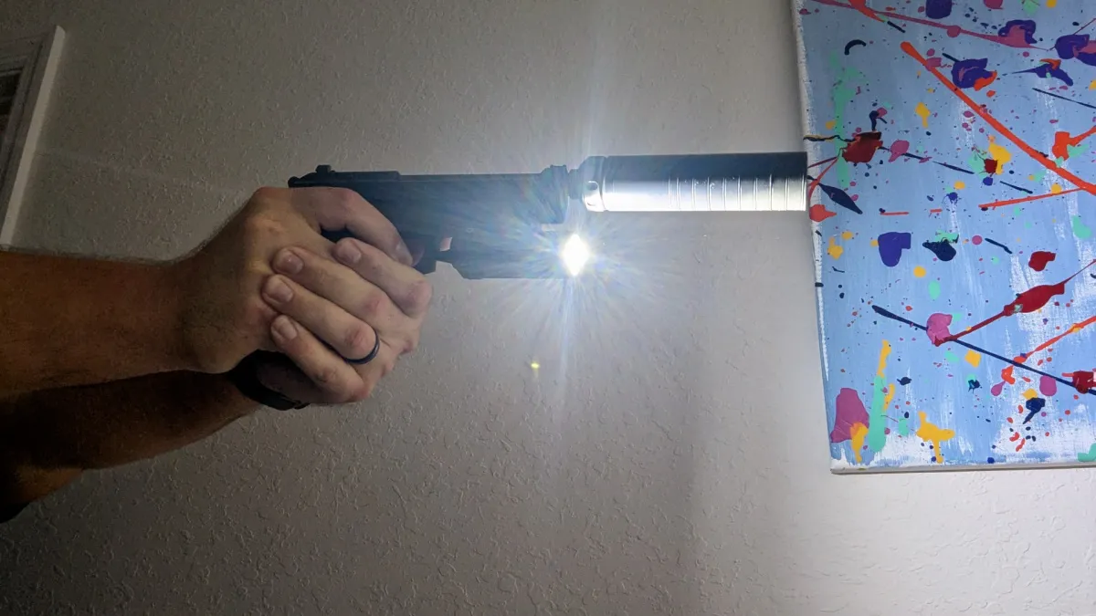 suppressed home defense handgun with weapon light on to demonstrate suppressor shadow