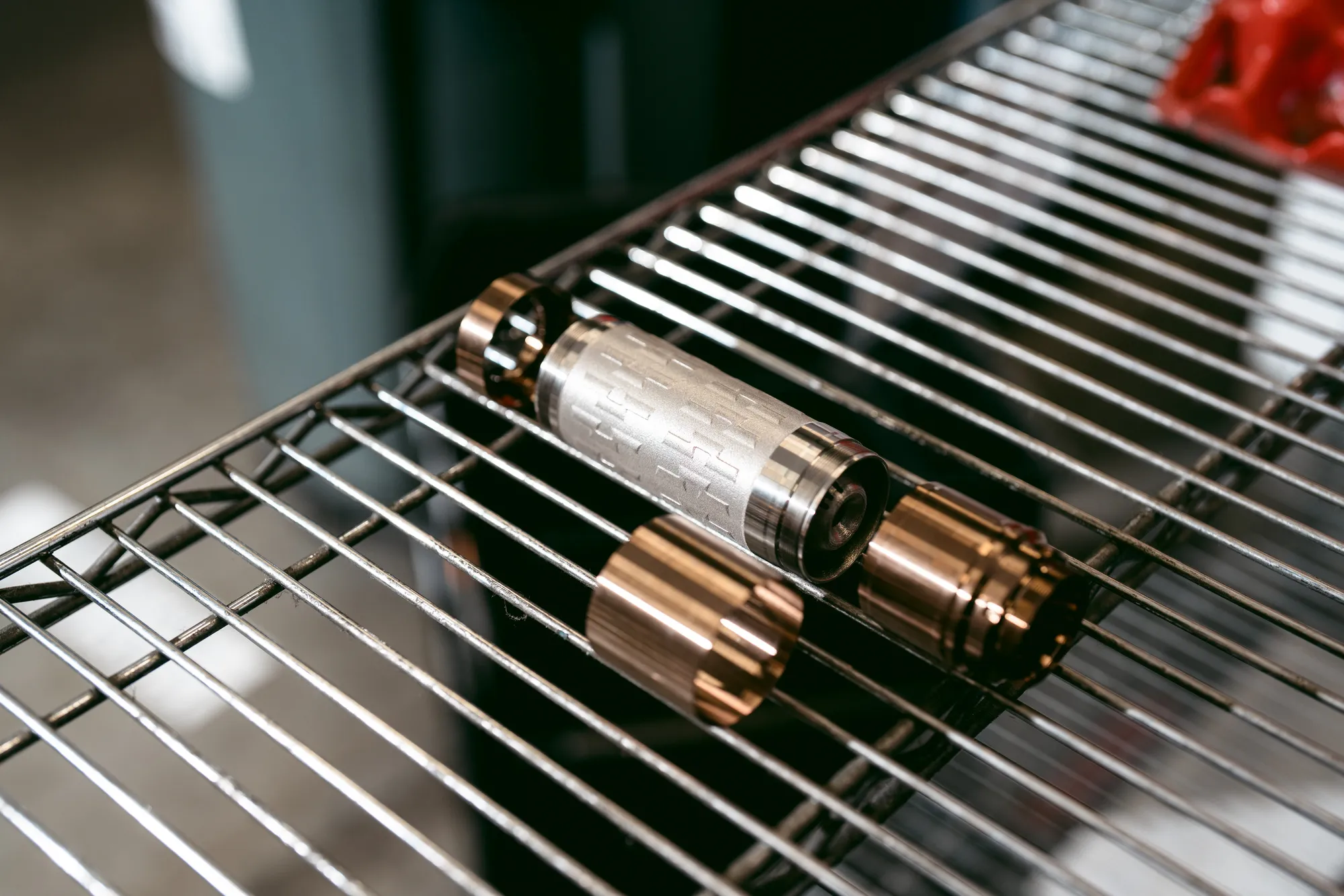 SilencerCo Velos LBP 3D printed inconel core with steel modules on a rack, ready to assemble