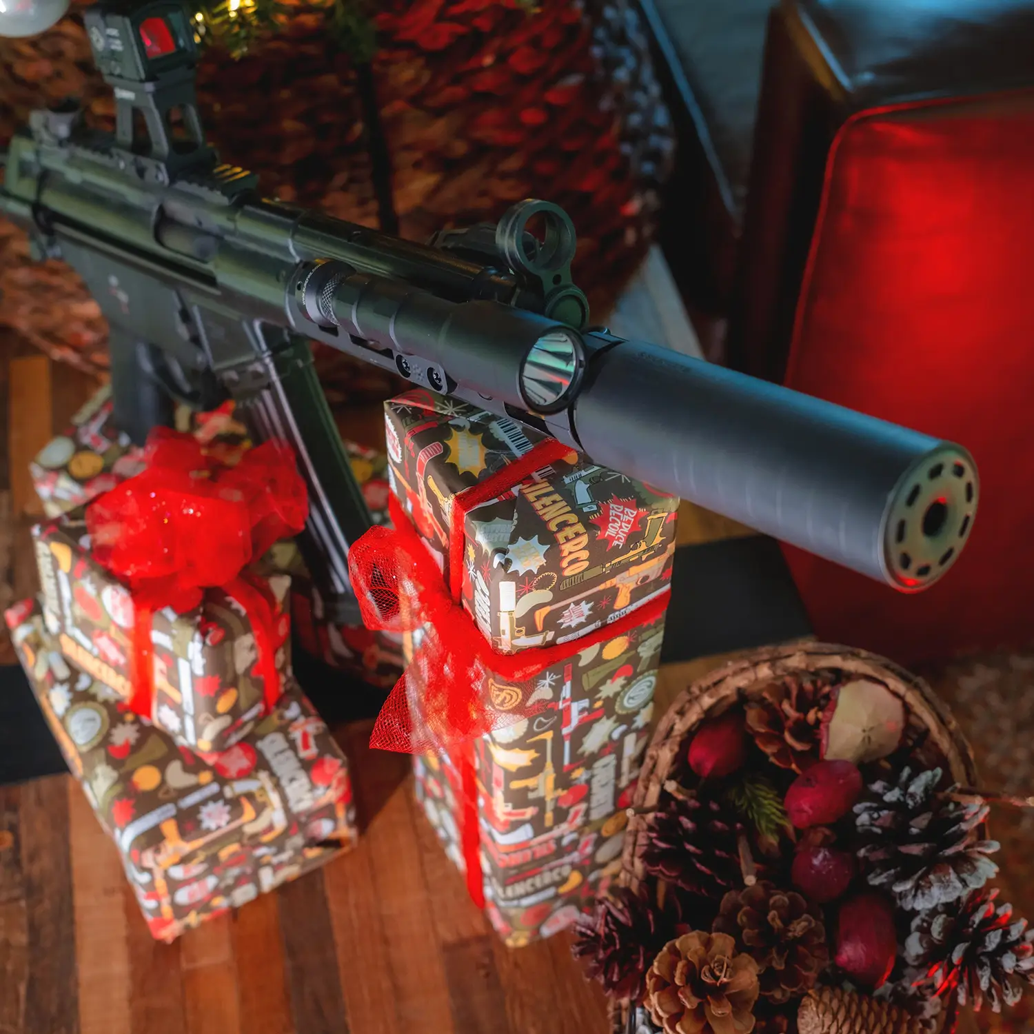 Gifts wrapped in SilencerCo Wrapping Paper with a Christmas gun.