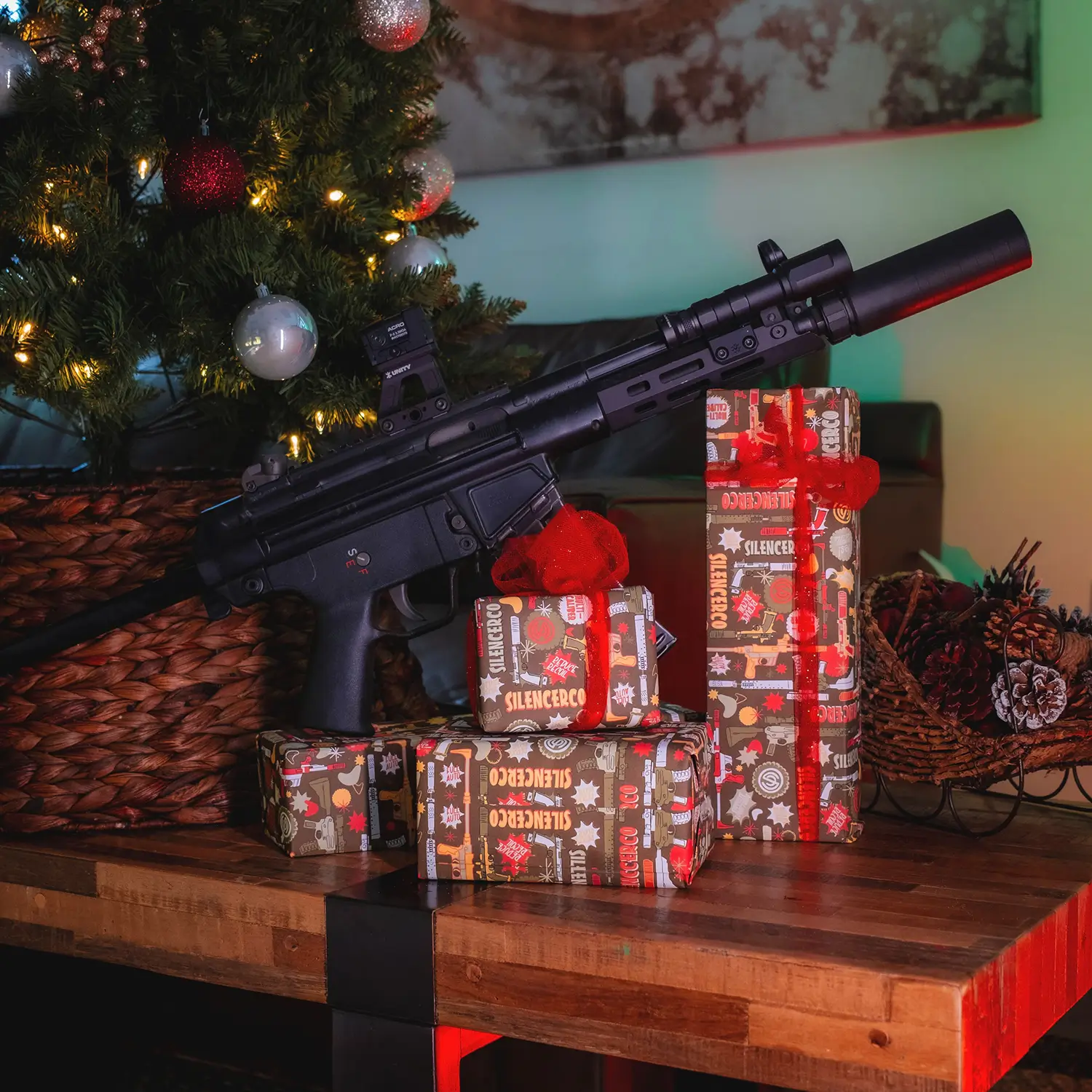 SilencerCo Wrapping Paper wrapped gifts with a gun under a tree.