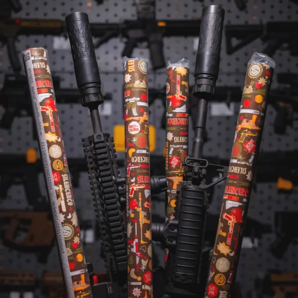 Rolls of SilencerCo Wrapping Paper displayed with guns.