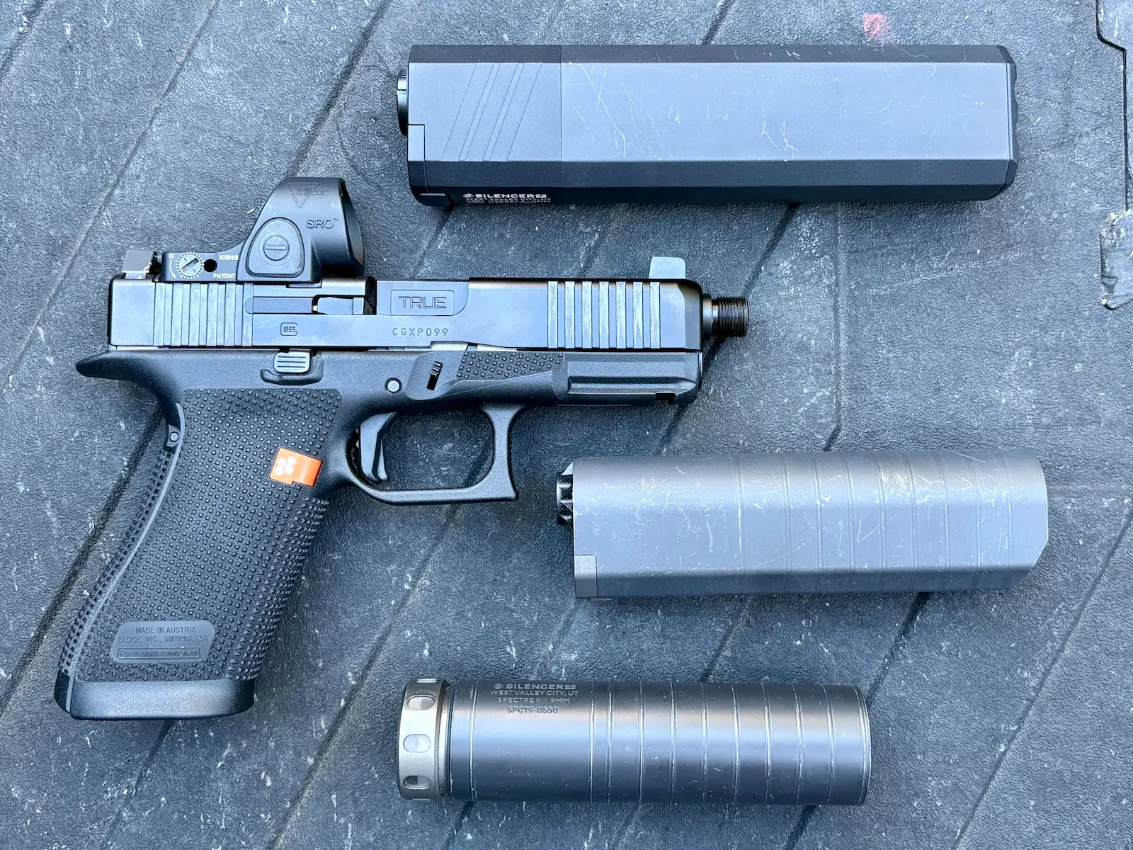 Gen 6 GLOCK G45 with threaded barrel beside SilencerCo Osprey 2.0, S98, and Spectre 9 suppressors