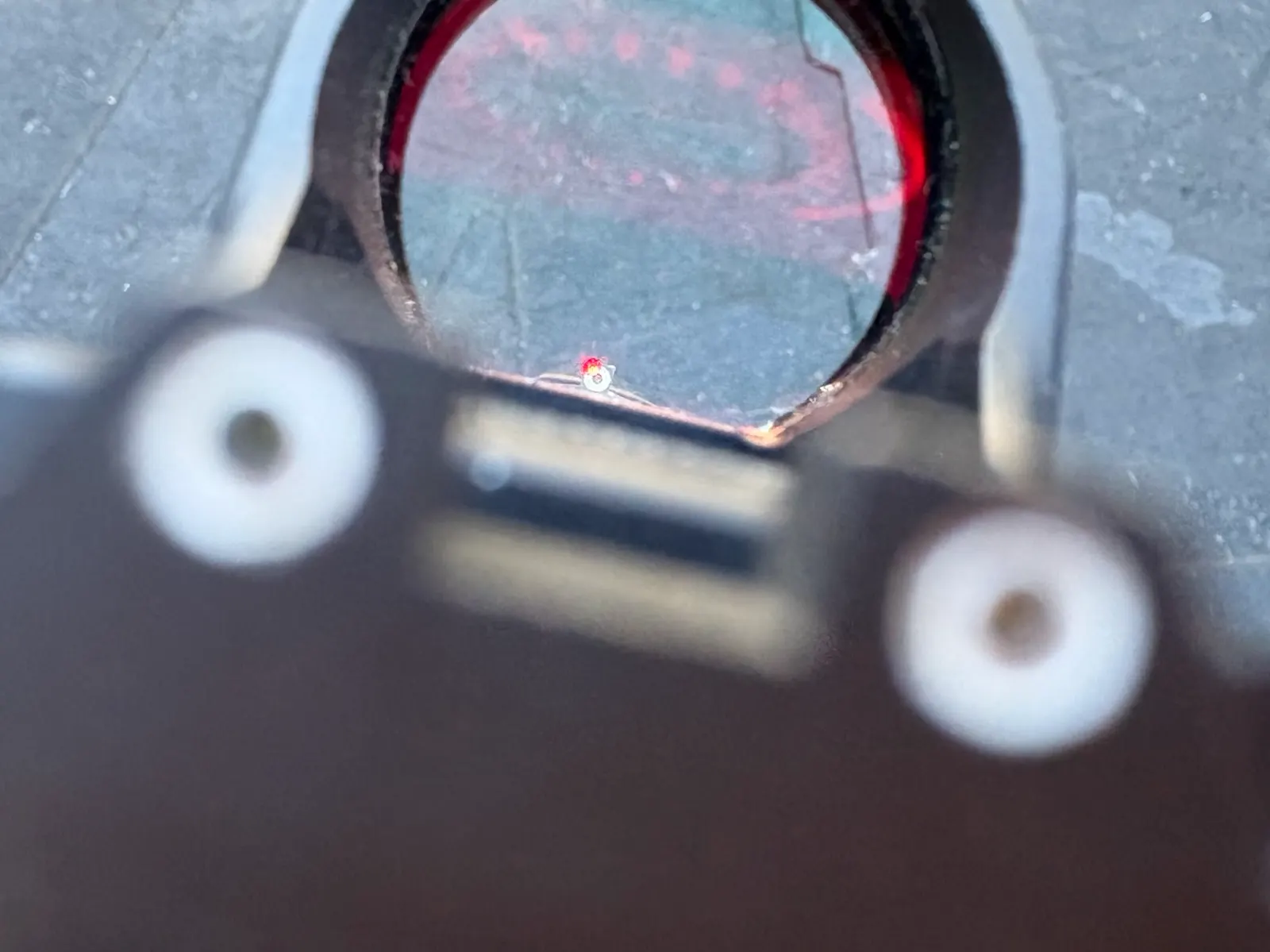 View through a red dot on a suppressed Gen 6 GLOCK, showing factory sight co-witness