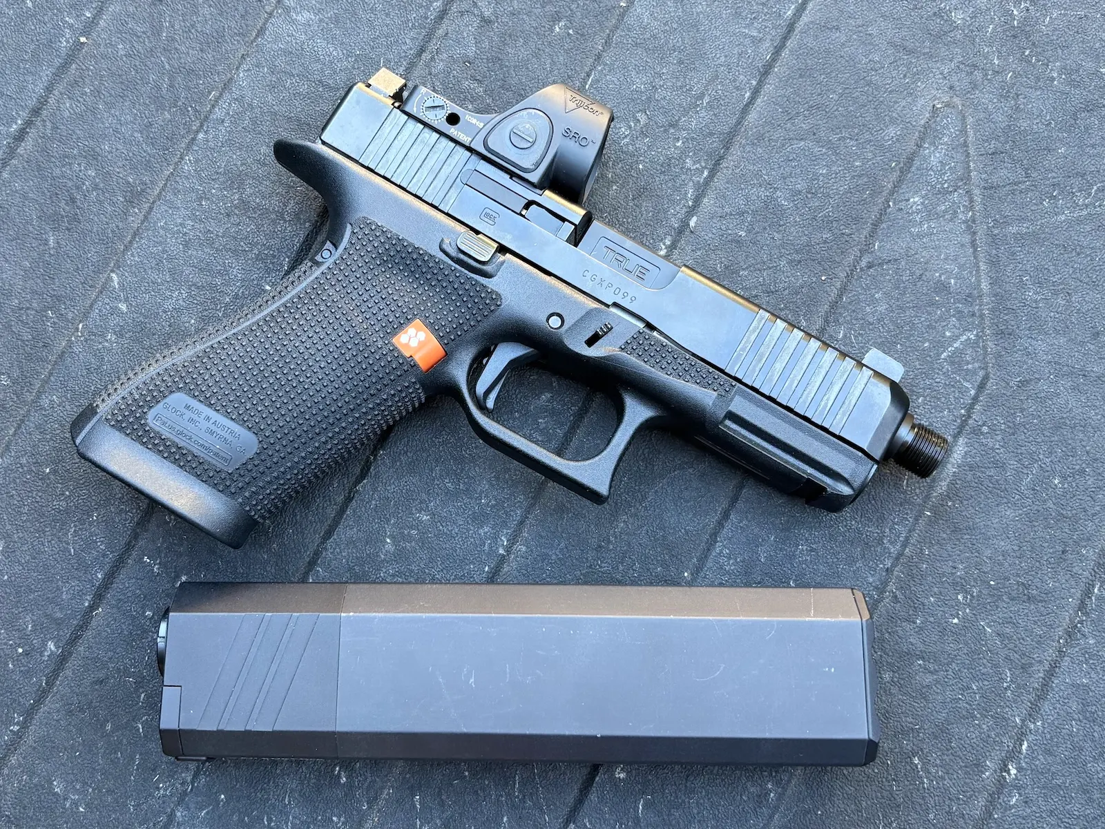 Gen 6 GLOCK G45 with a True Precision threaded barrel beside a SilencerCo Osprey 2.0 suppressor.
