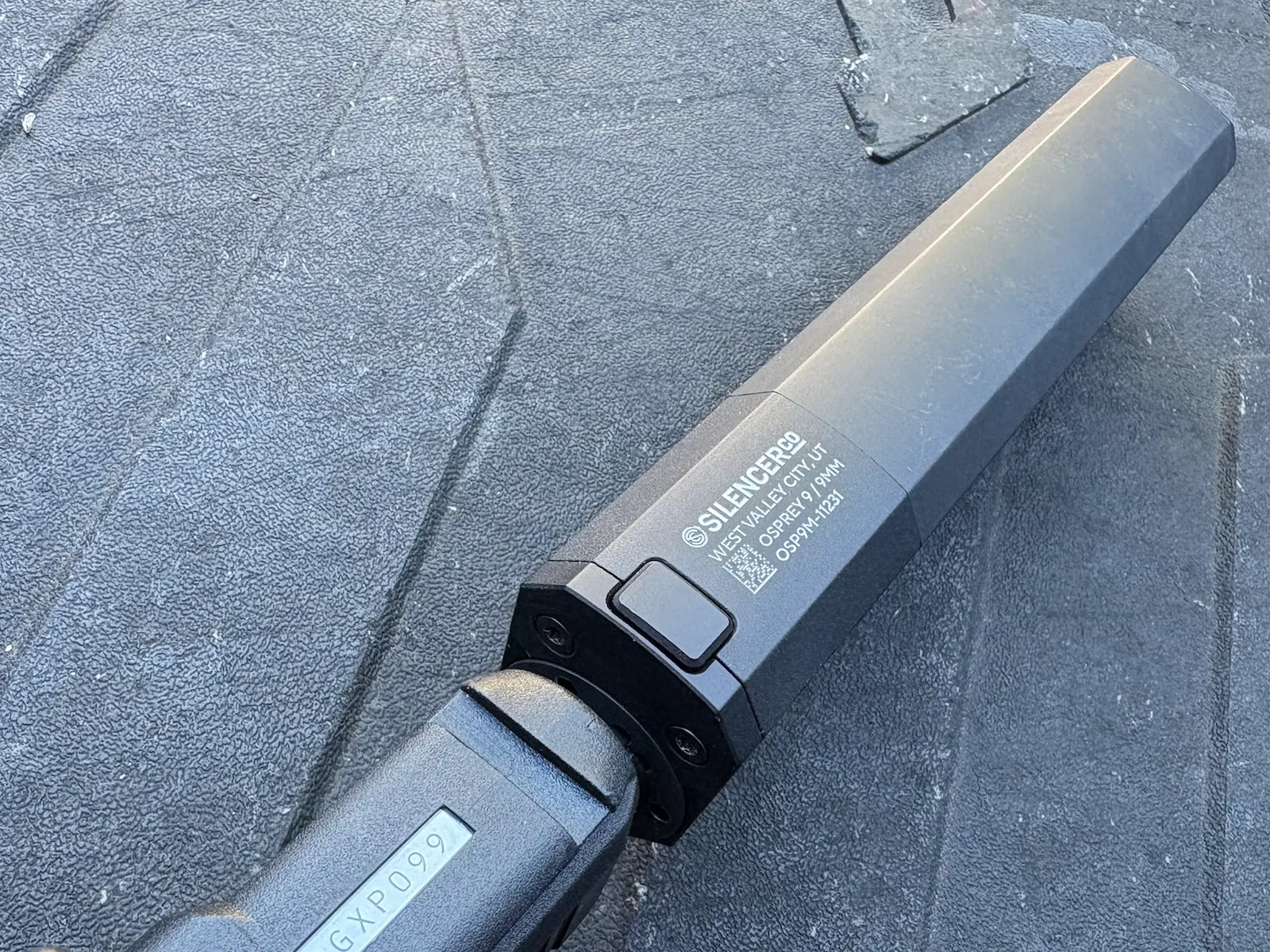 SilencerCo Osprey 2.0 suppressor mounted on a Gen 6 GLOCK, showing the alignment button.