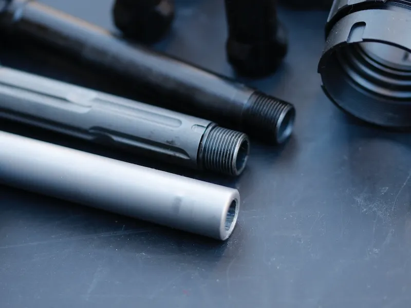 closeup shot of two threaded barrels and one non-threaded barrel