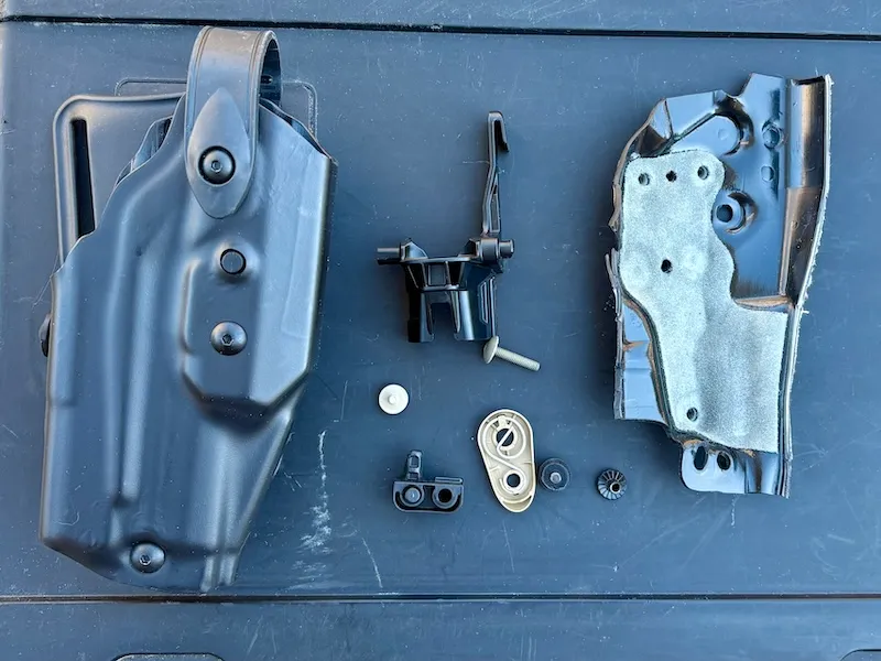 Safariland 6TS Holster parts disassembled, including Boltaron body, injection-moloded nylon belt attachments.