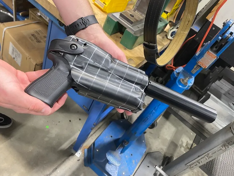 Safariland suppressor holster design and engineering - boltaron with grid marks conformed to profile of handgun, light, optic, and suppressor