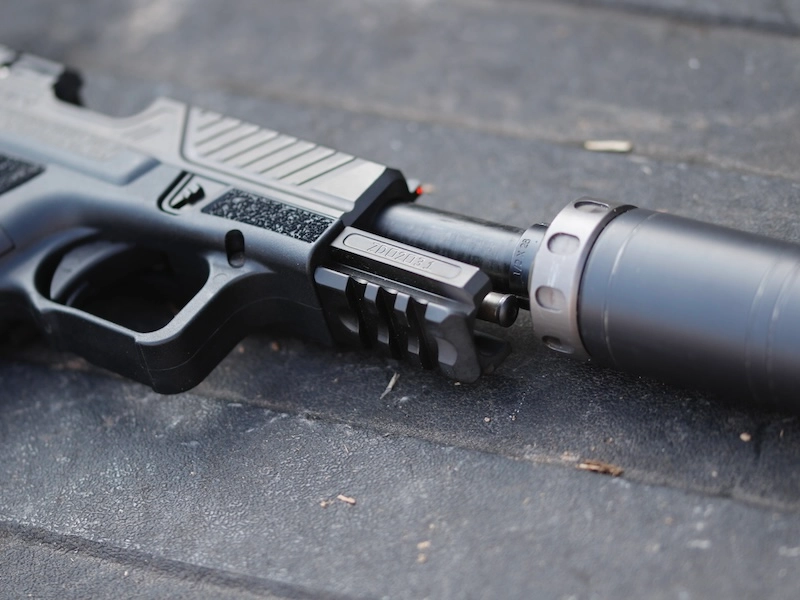 Glock clone with slide locked back and suppressor attached