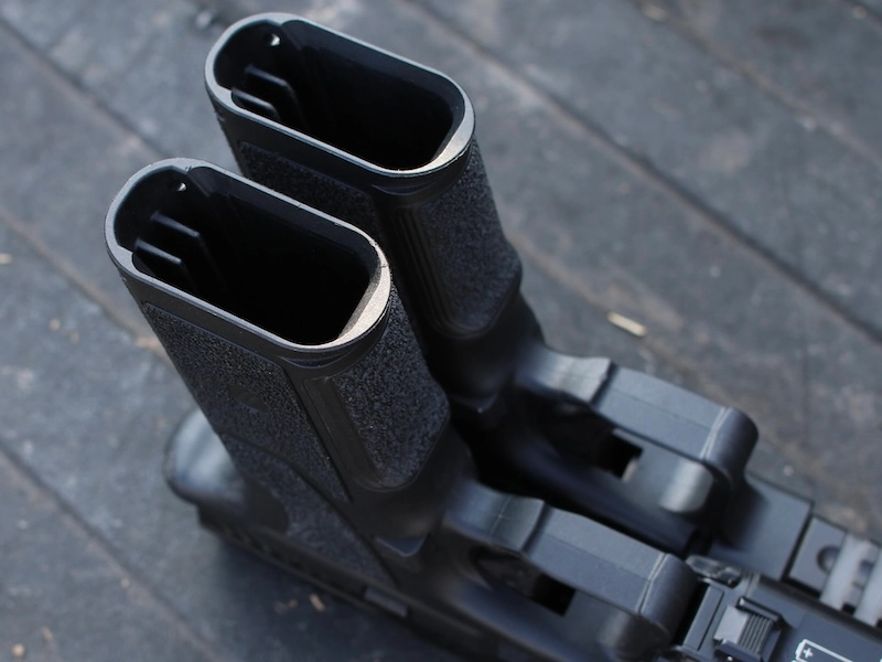 empty handgun magwells, side by side