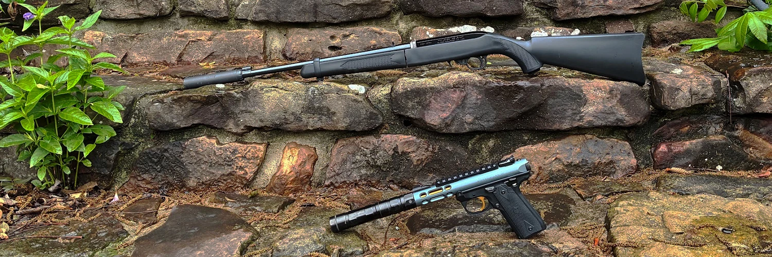 suppressed garden guns - ruger 10/22 with SilencerCo Sparrow and Ruger Mark IV LITE with SilencerCo Switchback 22 - on stone steps