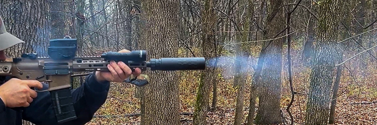 man shooting rifle with SilencerCo Velos LBP suppressor
