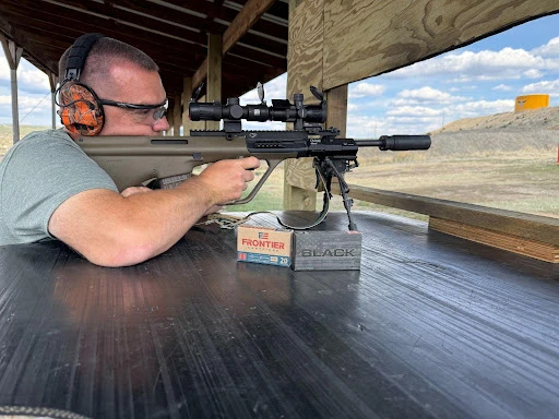 man shooting suppressed Steyr Aug with Velos LBP and Infitac thermal scope.