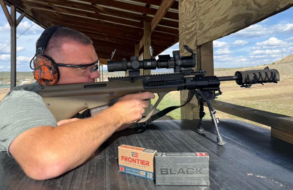 man shooting suppressed rifle with a suppressor cover to manage heat mirage