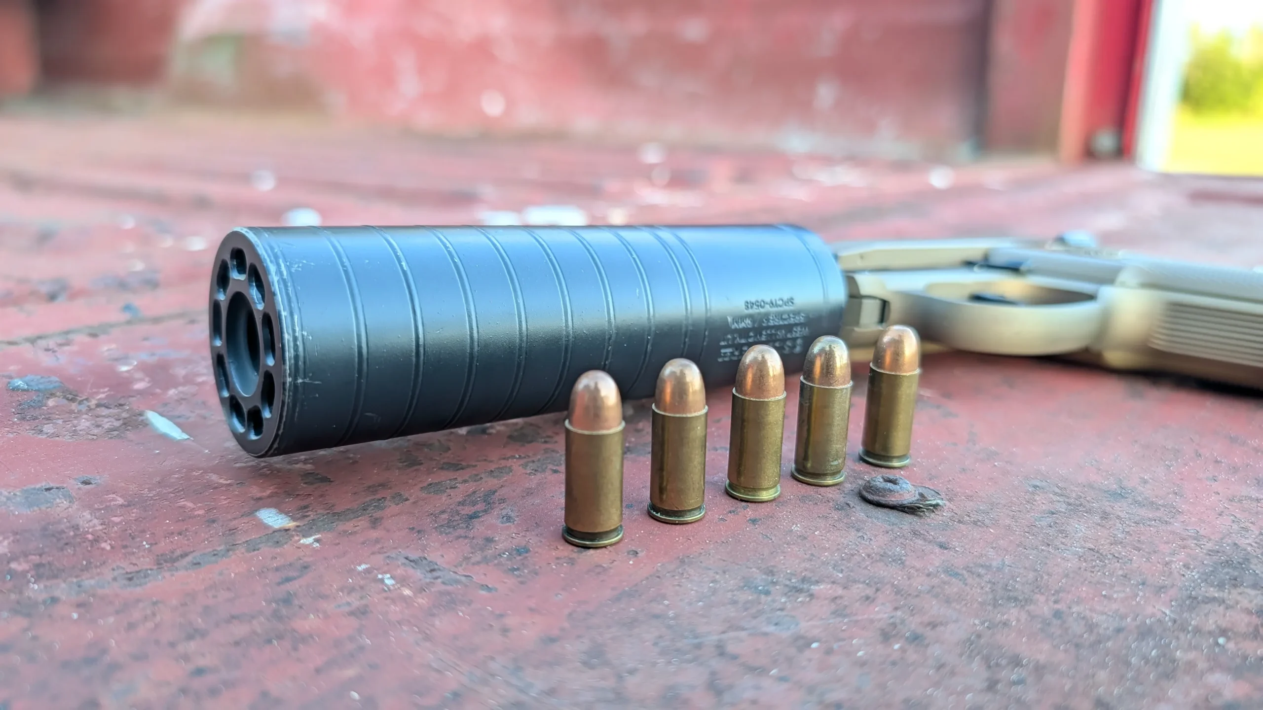 .32 ACP rounds standing in front of a suppressed 3032 tomcat on a truck bed