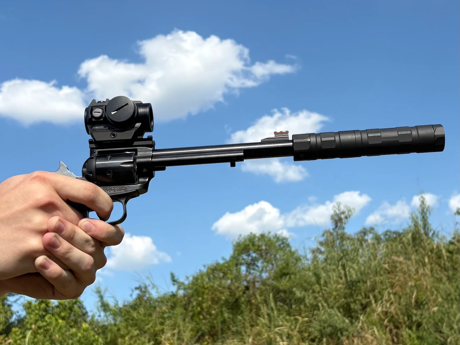 Close-up of trigger press shooting the Heritage Rough Rider Tactical Cowboy revolver, suppressed with SilencerCo Switchback .22