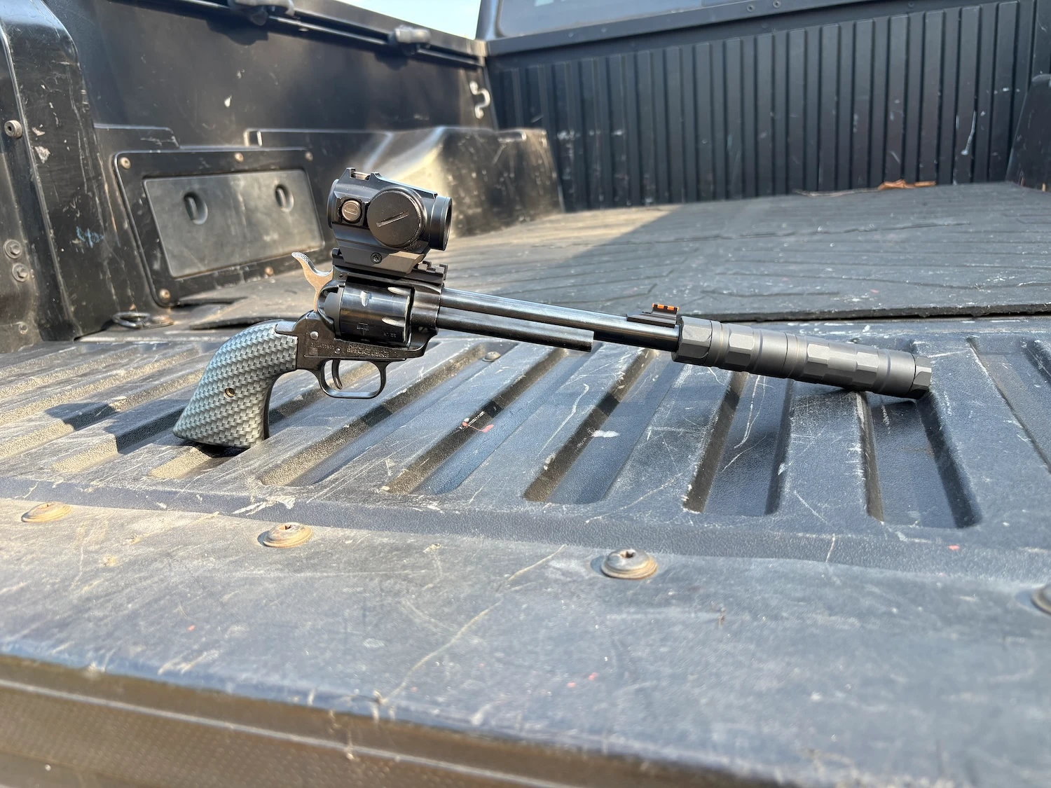 suppressed revolver on a truck bed