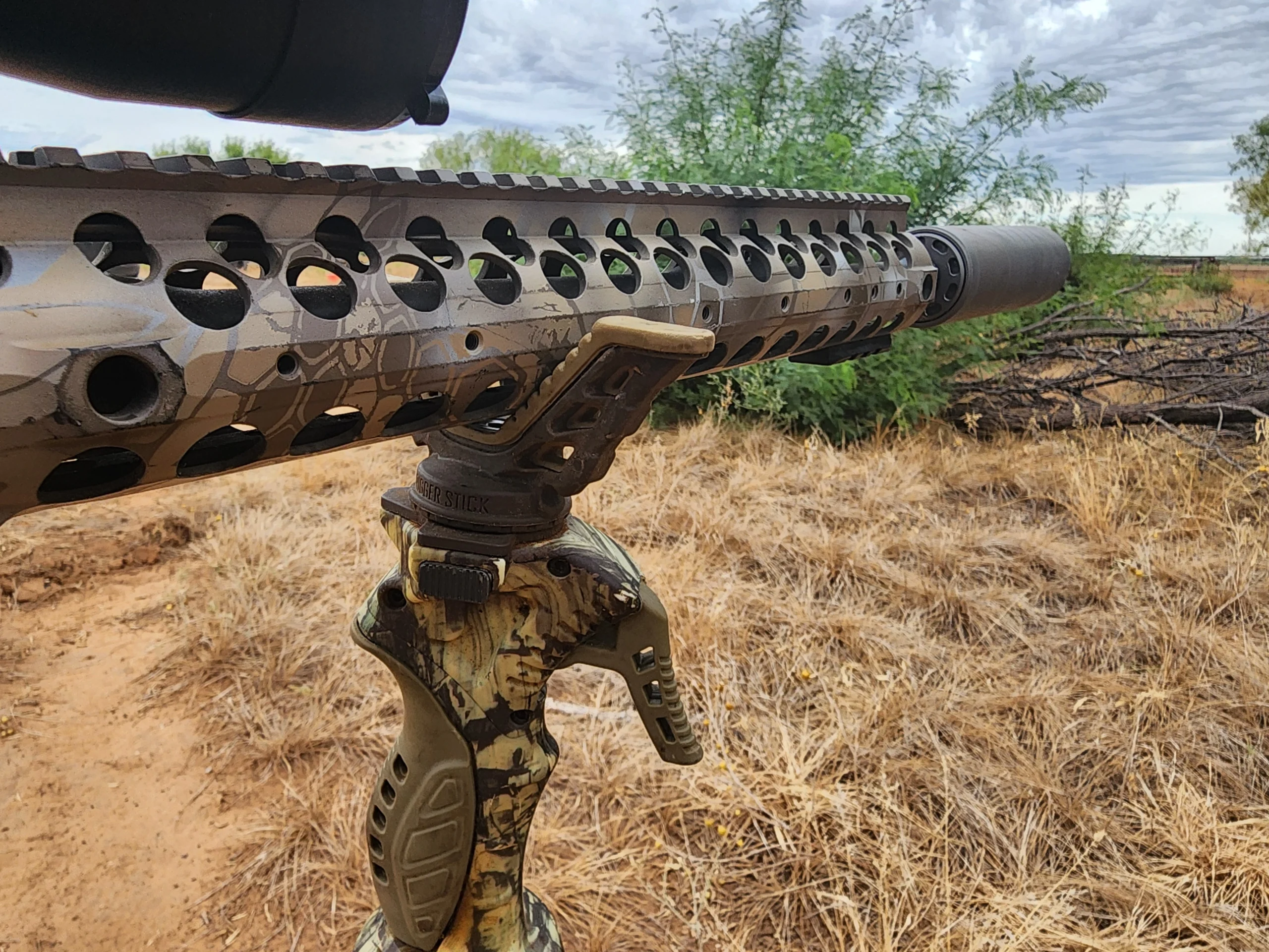 deer rifle with scythe-ti resting on shooting sticks for deer hunting
